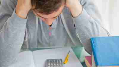 Dsycalculia in adults: A college student with ADHD and symptoms of dyscalculia is frustrated while working on a math assignment.