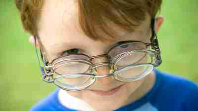 A boy with learning disabilities wears glasses.