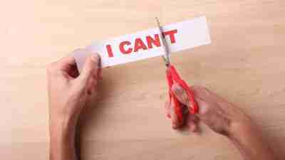 Scissors cutting the "t" off "I can't" to turn negative self talk into positive