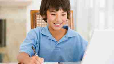 Young boy completing work for school without anxiety