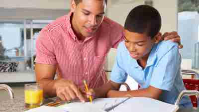 A boy and his father use ADHD homework strategies to finish assignments together.