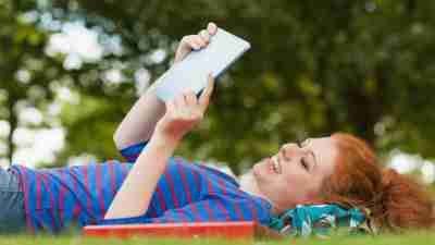 Girl student with ADHD studying outside in nature