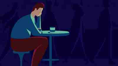 An illustration of a man with ADHD and depression sitting at a table.