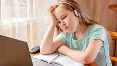 Lethargic girl with concentration deficit disorder (CDD) and ADHD doing remote school