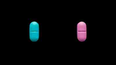 A red and blue pill with black background signifying the diagnosis of bipolar disorder