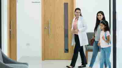 Female psychologist walking with patient in hall