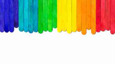 Colourful wooden popsicle sticks on white background
