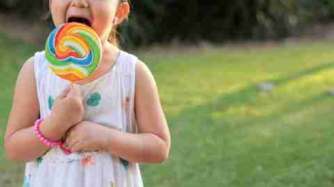 a child with ADHD enjoys a lollipop