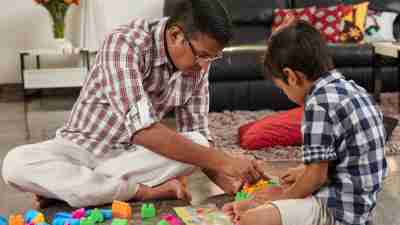 Father and ADHD son playing building blocks together