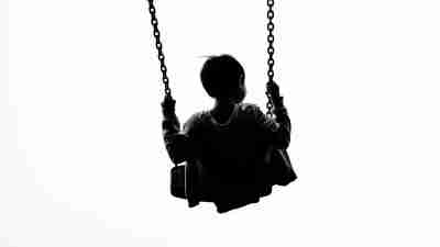 A child with symptoms of bipolar disorder swings at the park