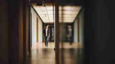 An ADHD teen with motivation problems walks down the school hallway